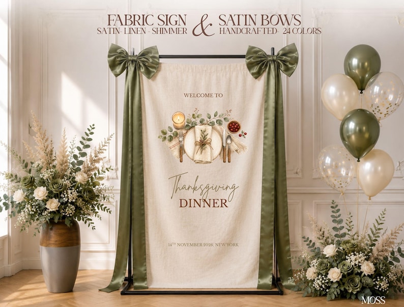 May include: A beige fabric sign hanging on a black metal stand, adorned with two large olive green satin bows. The sign features a printed illustration of a place setting with text reading Welcome to Thanksgiving Dinner 14th November 2026 New York.