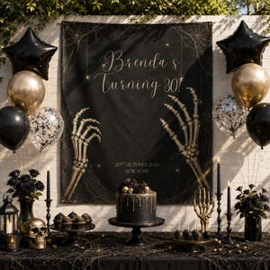 May include: A black backdrop featuring gold skeleton hands, spiderwebs, and the text Brenda's Turning 30! 20th October 2026 New York. The display includes black and gold balloons, a black cake with gold drips, black roses, and a gold skeleton hand.