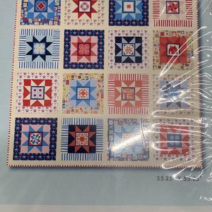 May include: A quilt kit titled "ALL STAR" featuring a patchwork design with red, white, and blue squares. The squares contain stars, geometric patterns, and a house motif. The kit measures 55.25 x 55.25 inches and is designed by Tamara Kate.