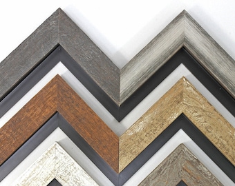 May include: Five different wood picture frames with a black painted edge. The frames are arranged in a chevron pattern, with the top frame being gray, the second frame being brown, the third frame being beige, the fourth frame being white, and the bottom frame being gray.