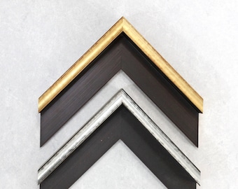 May include: Three picture frames with different colored trim. The top frame has a gold trim, the middle frame has a silver trim, and the bottom frame has a black trim.