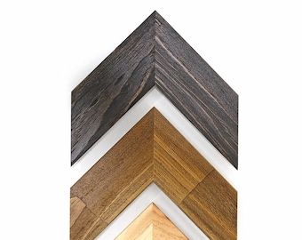 May include: Three wooden arrow shapes in different shades of brown, stacked on top of each other, with the lightest shade at the bottom and the darkest shade at the top.