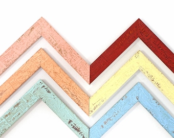 May include: Five wooden picture frames in a chevron pattern. The frames are painted in various pastel colors, including peach, light orange, yellow, light blue, and turquoise.