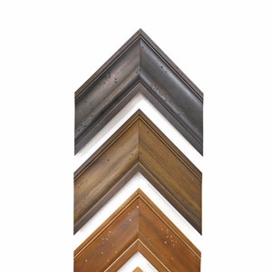 May include: Four wooden picture frames in different shades of brown, arranged in a pyramid shape. The frames are all the same size and have a simple, classic design.