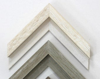May include: Four picture frame moldings in different wood tones, stacked in a pyramid shape. The top molding is a light beige, the second is a light gray, the third is a dark gray, and the bottom is a dark brown.