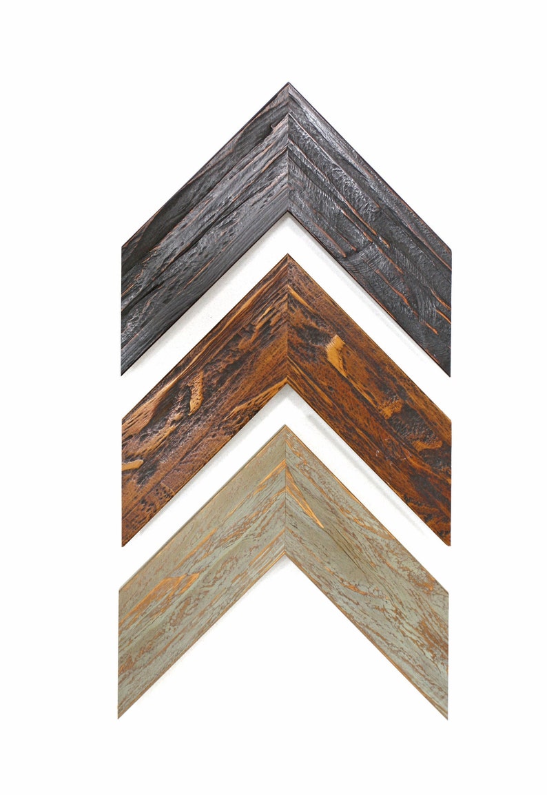 May include: Three wooden picture frame corners in a row, each with a different finish. The top frame is dark gray, the middle frame is brown, and the bottom frame is light green. The frames have a rustic, textured appearance.