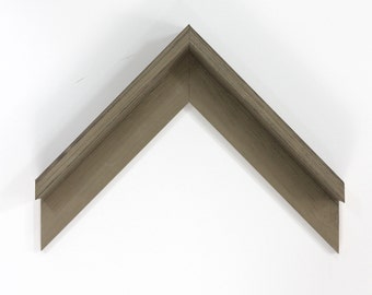 May include: A corner sample of a wood picture frame with a light brown finish and a wood grain pattern.