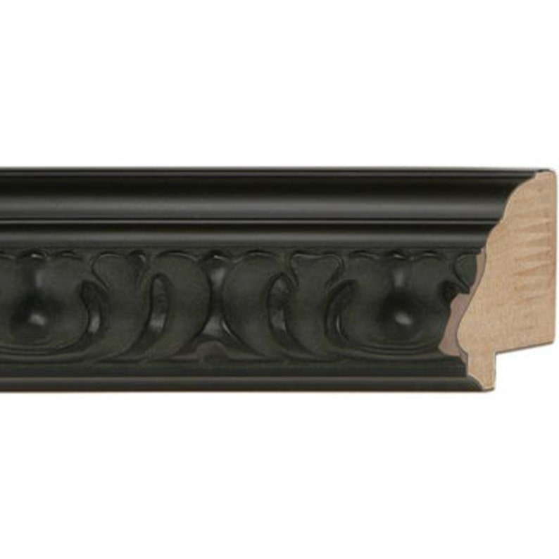 May include: Black picture frame with an ornate, carved design. The frame has a slightly raised edge and a smooth, flat surface.