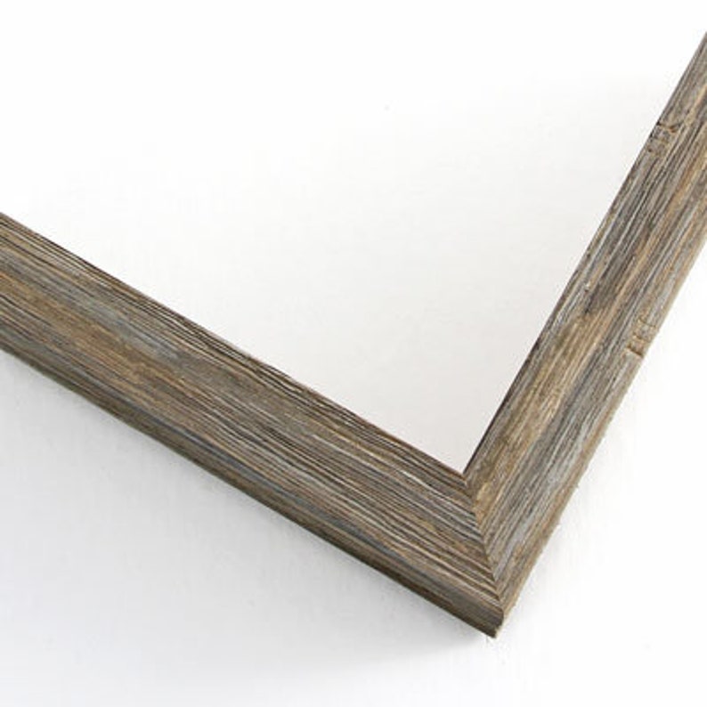 May include: A close-up of the corner of a rustic wood picture frame. The frame is a light gray color with a wood grain pattern.