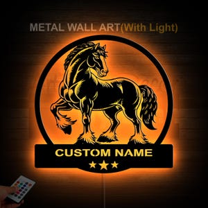 May include: Black metal wall art with a horse silhouette inside a circle, illuminated by an orange glow. The text "METAL WALL ART (With Light)" is at the top, and "CUSTOM NAME" with three stars is at the bottom.