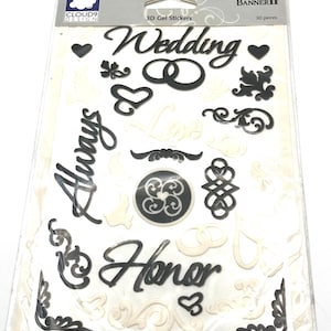 May include: A sheet of 3D gel stickers for weddings. The stickers include the words "Wedding", "Always", and "Honor", along with hearts, rings, and decorative flourishes. The package also includes the text "30 pieces".
