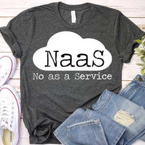 May include: Dark gray t-shirt with the text "NaaS" in a white cloud shape, with "No as a Service" below. White sneakers and blue jeans are visible in the image.
