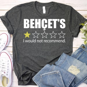 May include: A dark gray t-shirt with the text "BEHCET'S" and a 3-star rating. The text "I would not recommend." is below the rating.