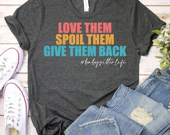 May include: A dark grey t-shirt with the text "Love them, Spoil them, Give them back #babysitterlife" in colourful text.