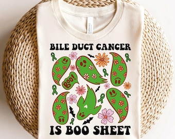 May include: A white t-shirt with a green, orange, and pink graphic design of ghosts, flowers, and bats. The text "Bile Duct Cancer is Boo Sheet" is printed in black on the shirt.