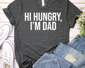 May include: A dark gray t-shirt with the text "Hi Hungry, I'm Dad" printed in white.