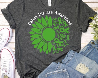 May include: A dark grey t-shirt with the text "Celiac Disease Awareness" and a green sunflower with green ribbons around it.
