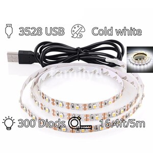 May include: A 16.4ft/5m long, white LED strip light with 300 diodes. The strip is powered by a USB cable and has a cold white color temperature. The strip is coiled up and the packaging includes a small paintbrush icon and the text "3528 USB".