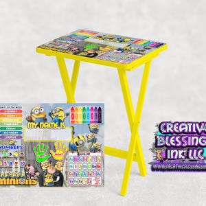 May include: A yellow folding table with a colorful Minion themed design. The table top features images of the Minions, letters of the alphabet, numbers, and days of the week. The table is made by Creative Blessings Ink LLC.