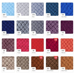May include: A color chart of yarn samples in various colors, including turquoise, gray, blue, petrol, teal, purple, red, pink, brown, and beige. The yarn is a soft, fuzzy texture and is arranged in a grid pattern. The chart includes the color number and name for each yarn sample.
