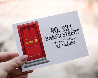 May include: A red door with a gold door knocker and a white step. The door is on a white card with the text "NO. 221 BAKER STREET Sarah & Jason 22.10.2022".