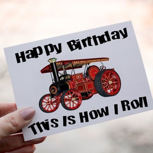 May include: A white card with black text that reads "Happy Birthday" and "This is How I Roll". A red and black steam engine is pictured on the card.