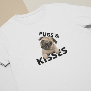 May include: White t-shirt with a black pug illustration and the text "Pugs & Kisses" printed on the front.