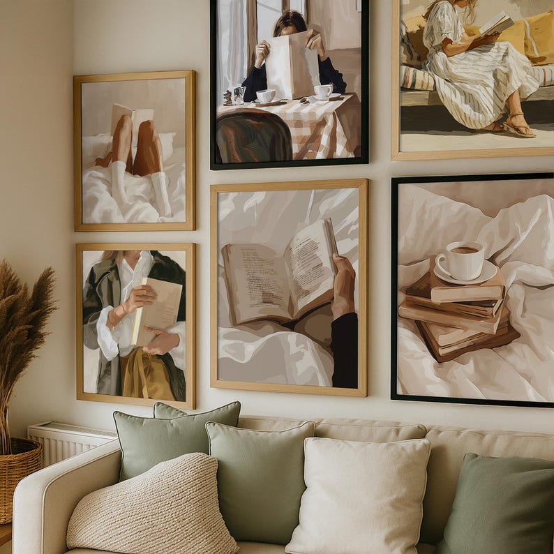 May include: A collection of framed art prints depicting scenes of people reading books. The prints feature neutral color palettes with subjects in various settings, including a bed, a cafe, and outdoors. The frames are in natural wood and black.