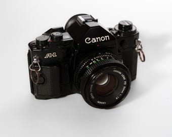 Canon AE-1 35mm Film Camera + Canon FD 50mm f/1.8 Lens | Near Mint Vintage SLR Kit | Manual (Spanish) + Box + Filter Ring