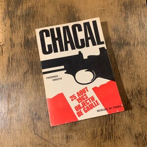 May include: A vintage book cover for "Chacal" by Frederick Forsyth. The cover features a black pistol silhouette over a cream background with the title in bold black letters. Red and white text at the bottom includes the date "25 AOUT 1963" and "OBJECTIF DE GAULLE".