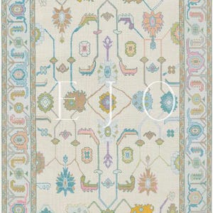 May include: A cream-coloured rug with a repeating pattern of teal, pink and yellow floral designs. The rug has a border with a repeating pattern of teal, pink and yellow geometric shapes.