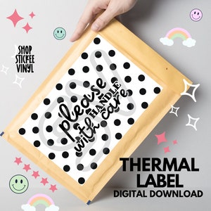 May include: A white thermal label with black polka dots and the text "Please handle with care" in a black handwritten font. The label is on a brown envelope.