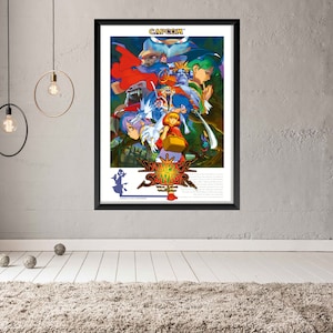 May include: A vintage-style poster for the video game "Vampire Savior: The Lord of Vampire", featuring a colourful illustration of characters from the game. The poster is framed in black and has the Capcom logo at the top.