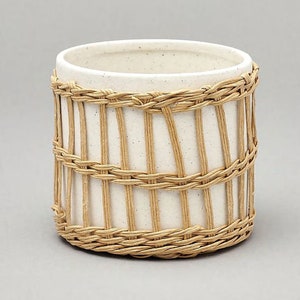 Stone plant pot with woven seagrass planter