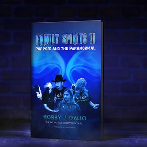 May include: A book titled "Family Spirits II: Purpose and the Paranormal" by Bobby J. Gallo. The cover features a blue and white design with images of people. The book is set against a dark blue background with a brick wall.