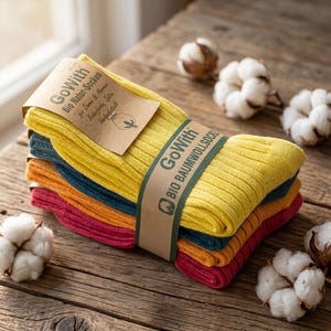 May include: A stack of four pairs of ribbed socks in yellow, teal, orange, and magenta, secured with a brown paper band labeled GoWith Bio Natur-Socken and GoWith Bio Baumwollsocke, featuring a small cotton boll illustration on the packaging.