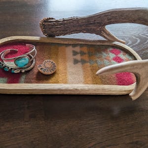 May include: A rustic wooden sign with the text "Welcome to our home" in white lettering. The sign features a distressed finish and a simple, inviting design, perfect for entryway decor.