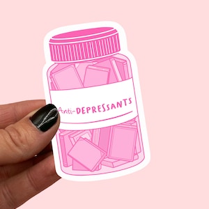 May include: A pink sticker of a glass jar filled with books. The label on the jar reads "Anti-DEPRESSANTS".