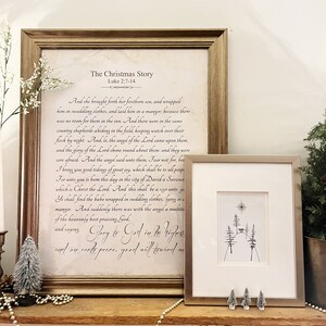 May include: A framed print with a white background and black text. The text is a passage from the Bible, Luke 2:7-14, telling the story of the birth of Jesus. The title of the print is "The Christmas Story". Below the text is a handwritten inscription that reads "Glory to God in the highest and on earth peace, good will toward men".