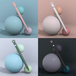 May include: Four different colored styluses with paw print toppers are shown on top of four different colored spheres. The styluses are pink, white, green, and black. The spheres are light blue, white, light green, and gray.