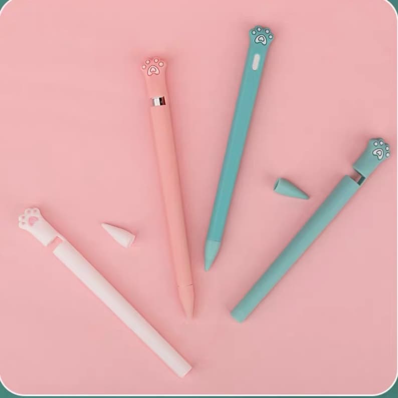 May include: Three pink and green silicone covers for Apple Pencil with a paw print design. The covers are designed to protect the Apple Pencil and add a touch of personality.