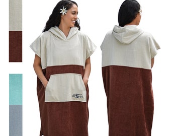 May include: A hooded towel with a beige top and brown bottom. The towel has a pocket on the front and the text "Aloha" embroidered on the pocket.