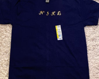 May include: A navy blue t-shirt with the text "N I K L" embroidered in gold on the front.