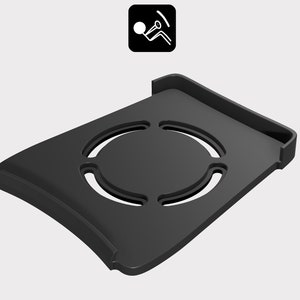 May include: Black plastic phone stand with a circular cutout in the center. The stand has a raised lip on the back edge.