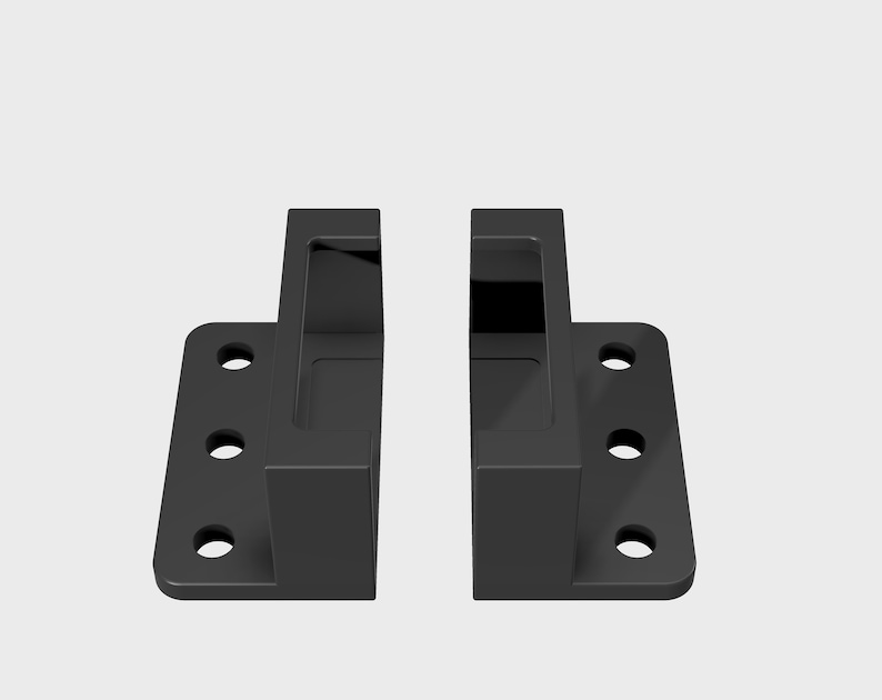 May include: Two black plastic brackets with four holes each. The brackets have a rectangular opening in the center.