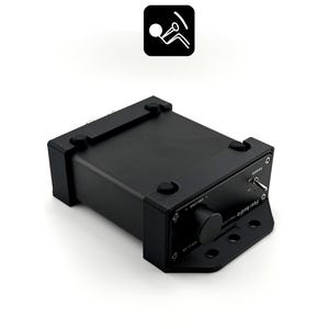 May include: A black Fosi Audio amplifier featuring a front-facing volume control knob, a power toggle switch, and a mounting bracket with three circular holes. The device has a rectangular chassis with four small rubber feet on the top surface.