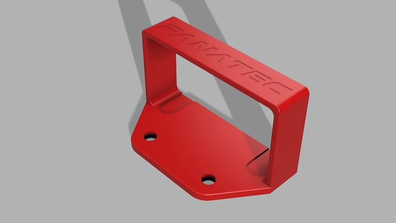 Puede incluir: Una manija de pl&aacute;stico roja con la palabra "FANATEC" en relieve en la parte superior. La manija est&aacute; unida a una base de pl&aacute;stico roja con dos agujeros para tornillos.