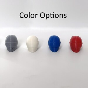 May include: Six miniature helmets in different colors: black, gray, white, blue, red, and yellow.  "Color Options" is written above the helmets.
