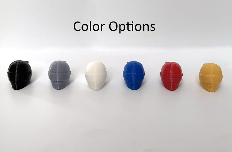 May include: Six miniature helmets in different colors: black, gray, white, blue, red, and yellow.  "Color Options" is written above the helmets.