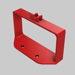May include: Red plastic wall mount with a rectangular opening and two holes on the bottom.